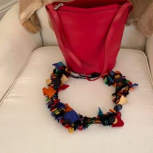 A two sided,red and beige Valentino bag,one side red,the other side beige.